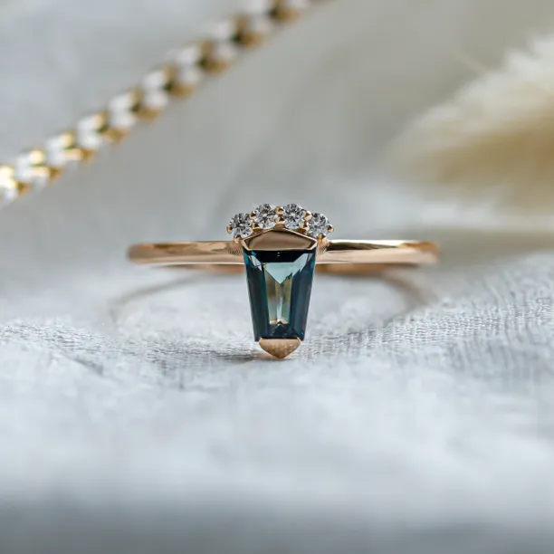 Unusual gold ring with teal sapphire and side diamonds AZRAQ Image