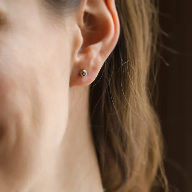 Minimalist gold earrings with salt and pepper diamonds in bezel setting NOLA Image