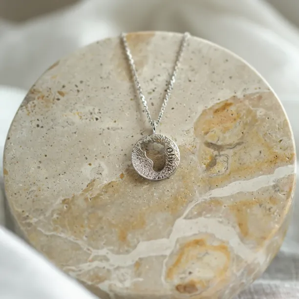 Gold necklace with unusual surface and baby foot trace LEE Image