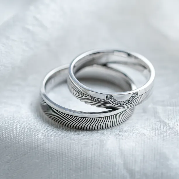 Wedding rings with abstract relief and diamonds OMEGA Image