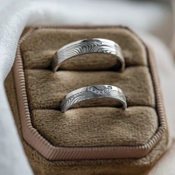 Wedding rings with abstract relief and diamonds OMEGA Image