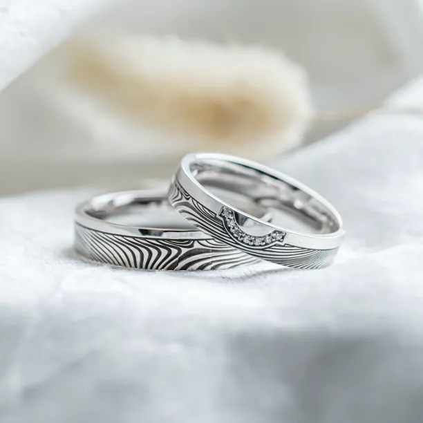 Wedding rings with abstract relief and diamonds OMEGA Image