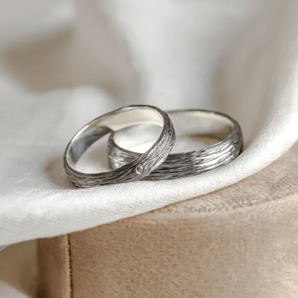 Black wedding rings with woodbark surface EBEN Image