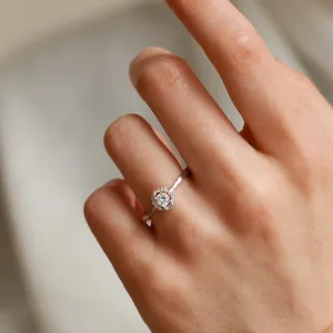 A gold ring with halo stones and diamonds HALOY