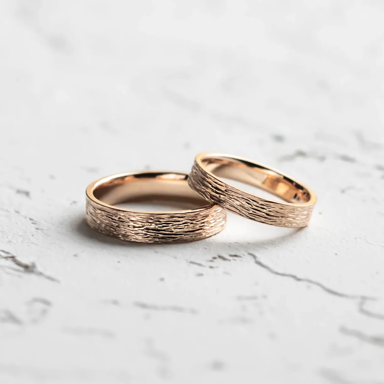 Unusual wedding bands with woodbark surface.