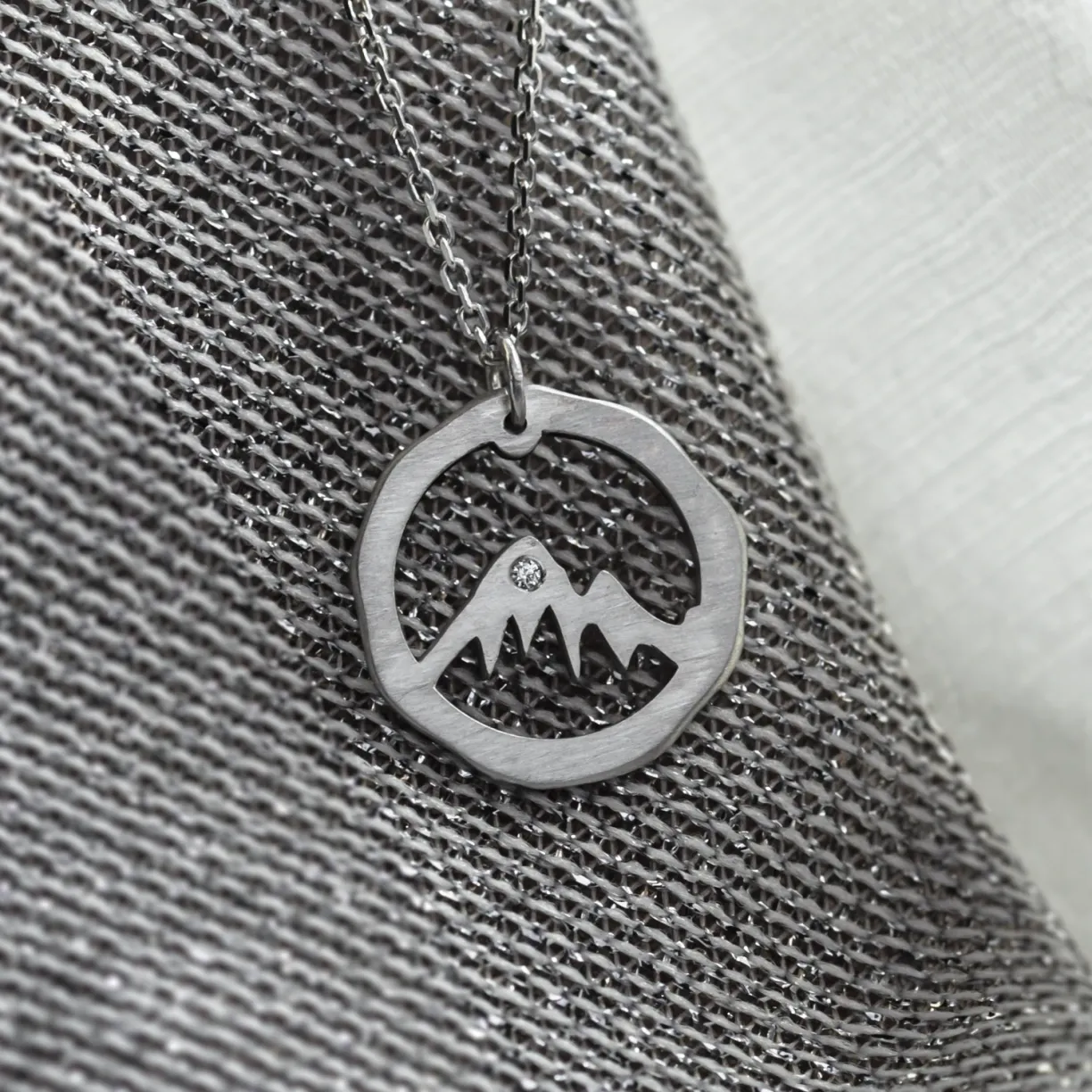 gold necklace with mountain motive